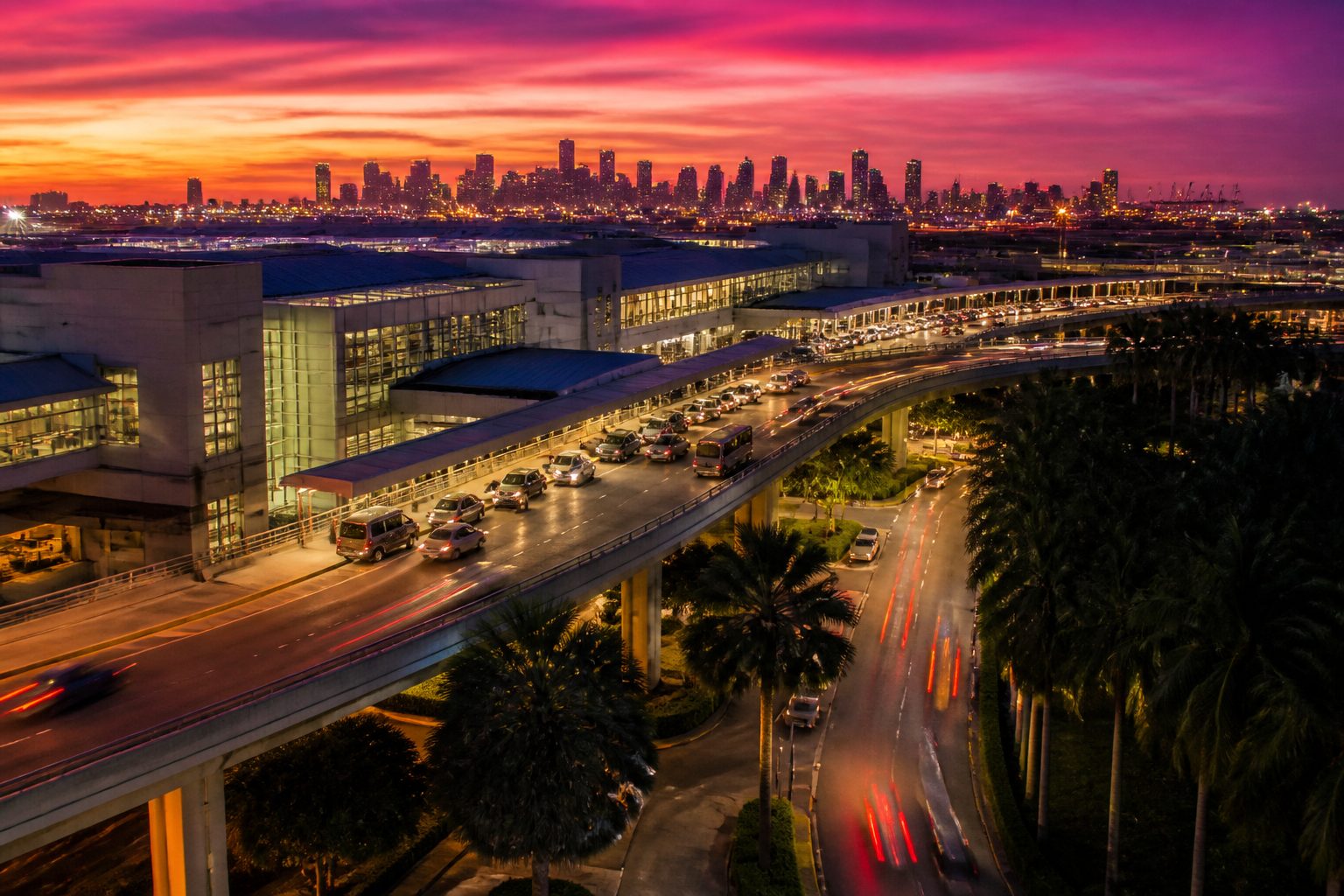 Aerial view of Miami International Airport with ground transportation vehicles lined up at passenger pickup area